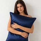 Navy blue silk pillowcase on a bed